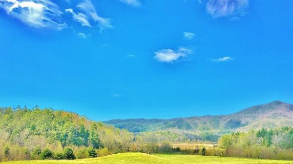 Wooded ridgeline in far distance with blue sky above