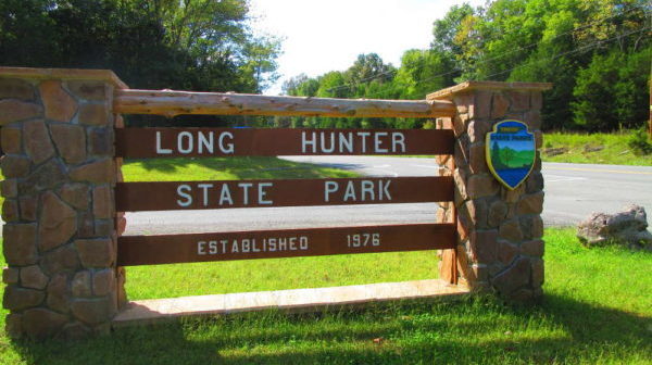 Two stacked stone pillars with wood sign: Long Hunter State Park
