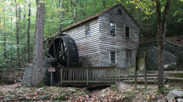 Old Wooden Water Mill in forested area