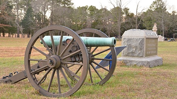 Civil War cannon with monument in background
