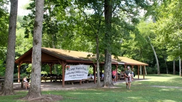 Covered Picnic Shelter with trees and green grass