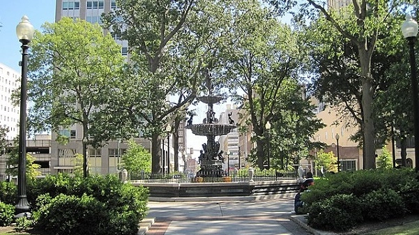 City park with trees and a fountain