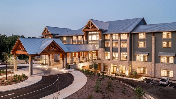 multi-story lodge with green lawn